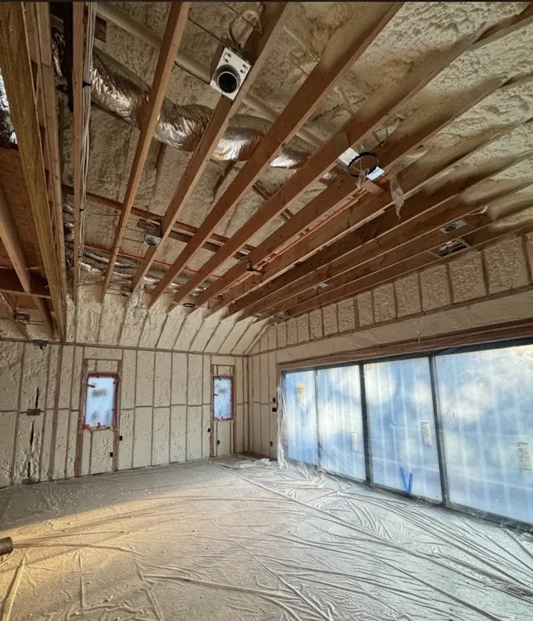 Interior walls and ceiling insulated with spray foam during new construction in Millburn